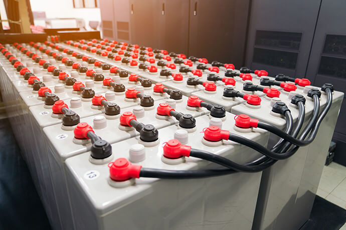 Rows of batteries for an industrial backup power system to supply electricity during shutdown phase.